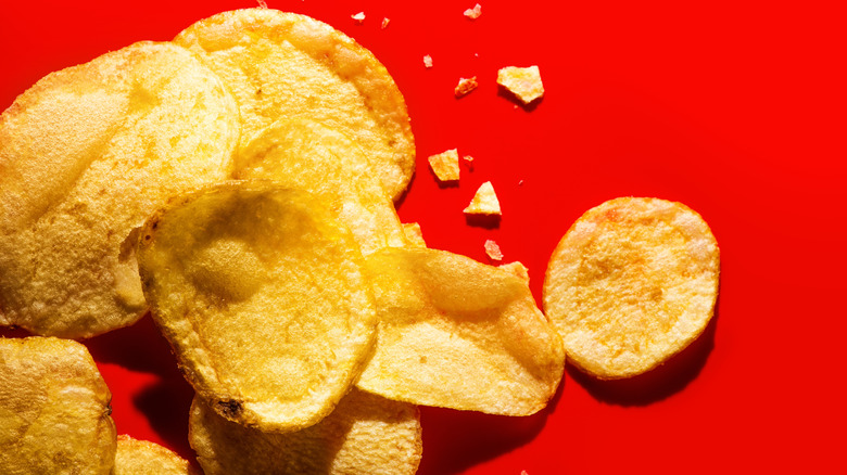 Potato chips on a red surface