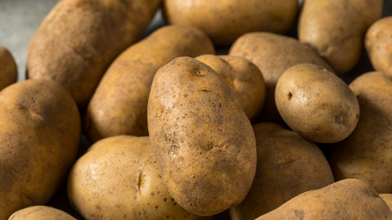 Whole unpeeled raw russet potatoes