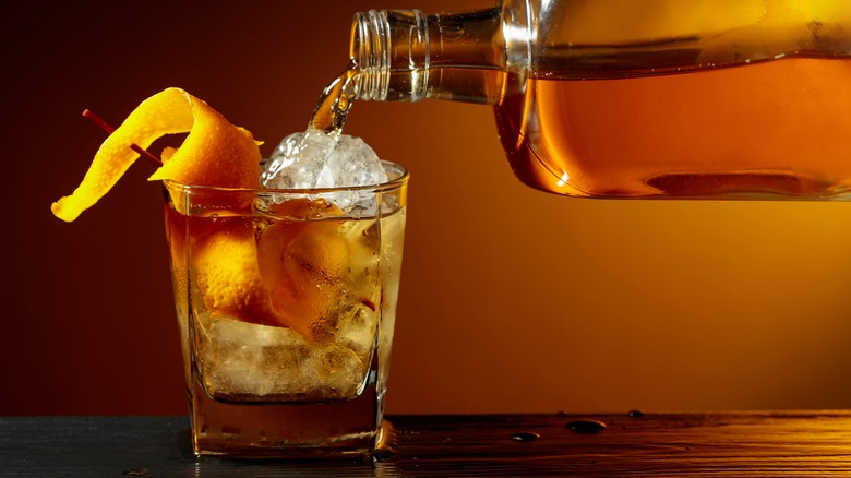 Whiskey pouring into an Old-fashioned