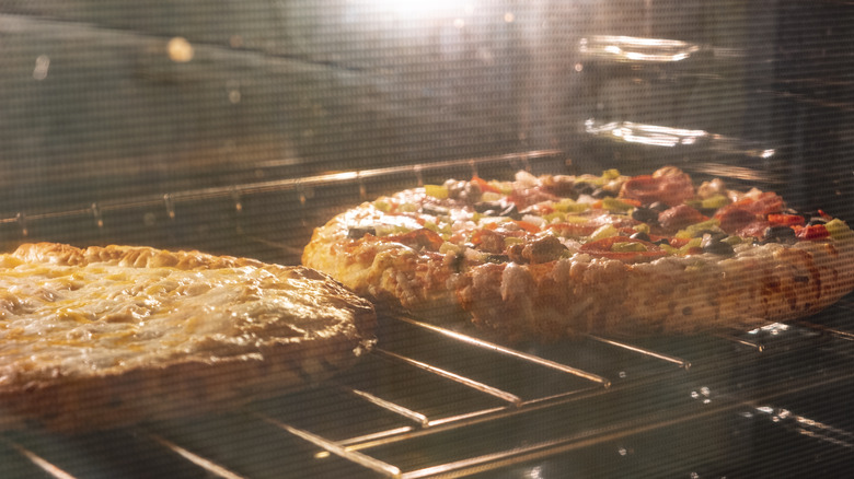 Two pizzas in an oven