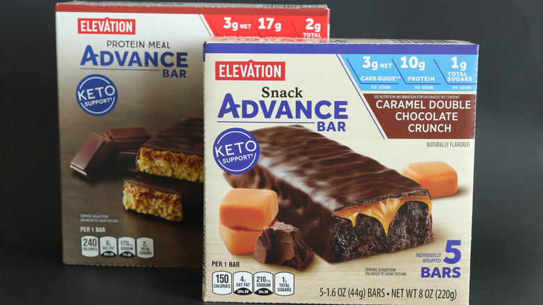 Two boxes of Elevation Advance bars next to each other on a black background