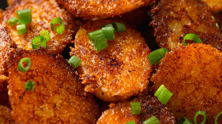 Close-up of parmesan crusted potatoes with scallions