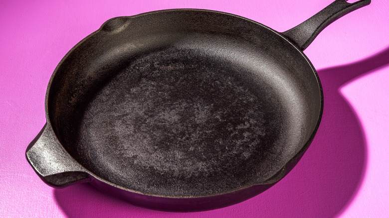 a cast iron skillet against a purple background