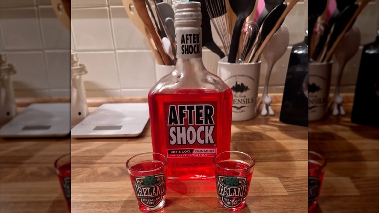 Aftershock bottle and two shot glasses