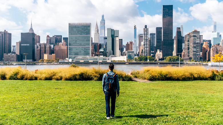 A person standing in front of New York City high rises