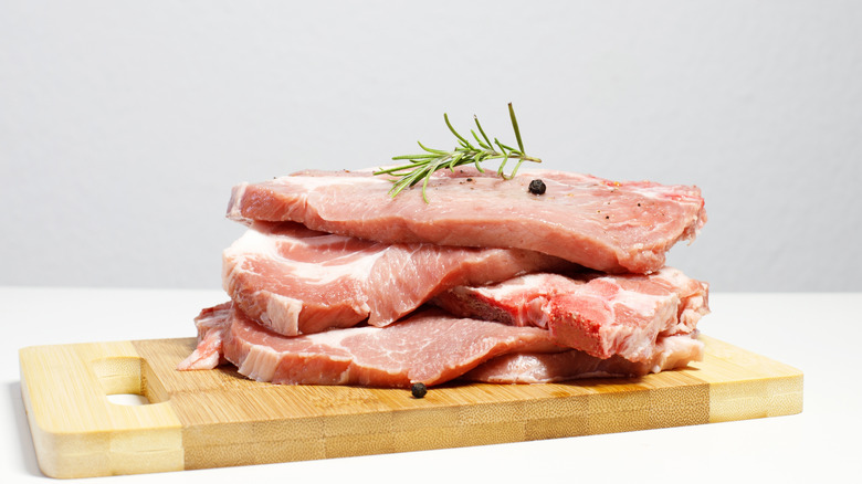 Slabs of raw pork on cutting board