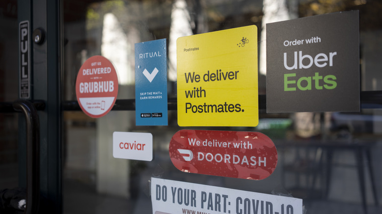 delivery app signs in restaurant window