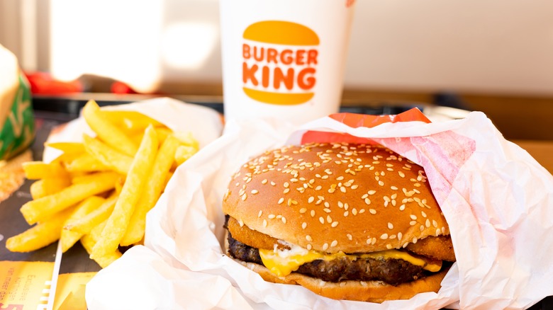 Burger King burger, fries and drink on a table. 