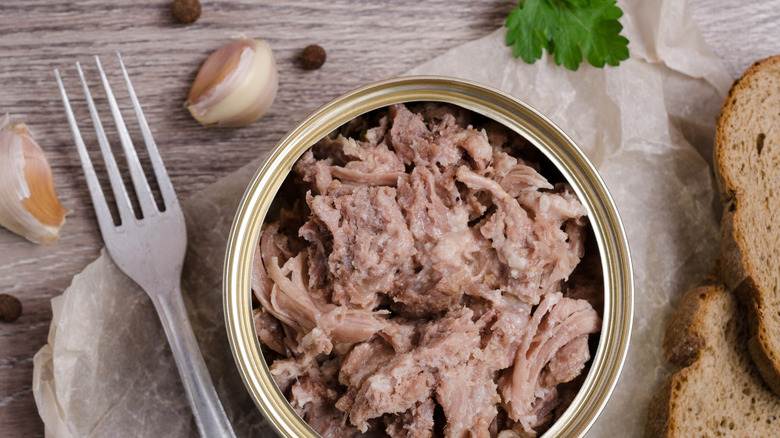 Open can of chicken on a table