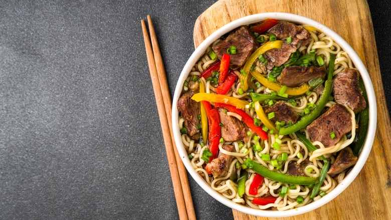 top down view of prepared lo mein with chopsticks on the side