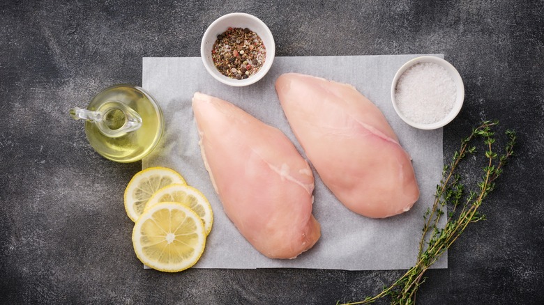 Raw chicken breast on white parchment