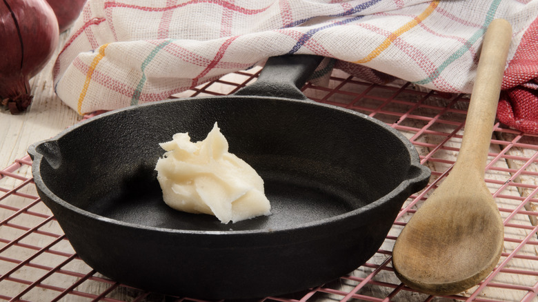 A heap of tallow in a cast iron pan