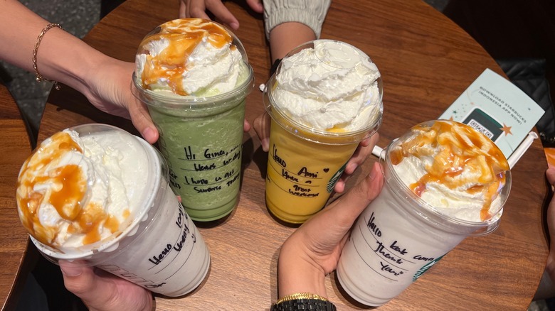 Starbucks drinks with Sharpie writing on the cups