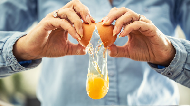 Hands cracking an egg