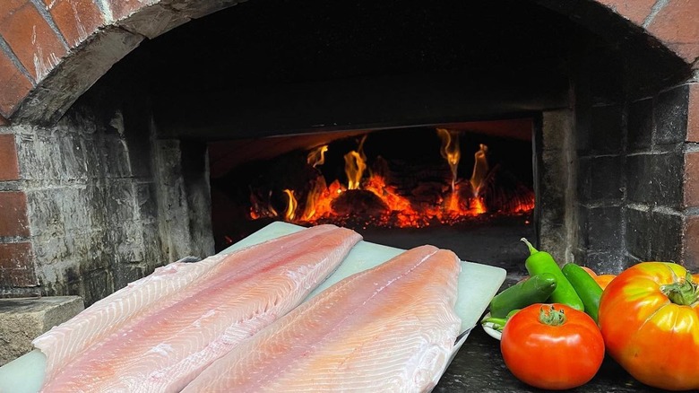 Ivory king salmon fillets in front of wood oven