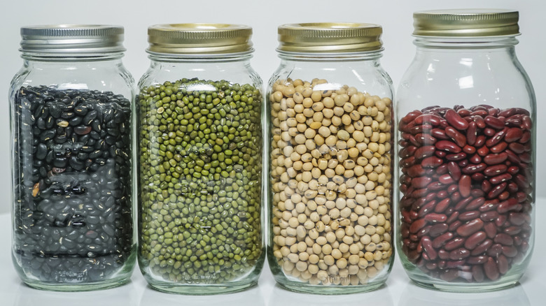 A variety of dried beans in mason jars