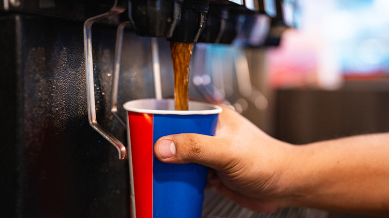 A man getting a fountain soda