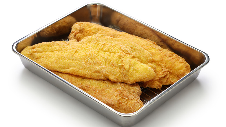 Fried fish resting in pan