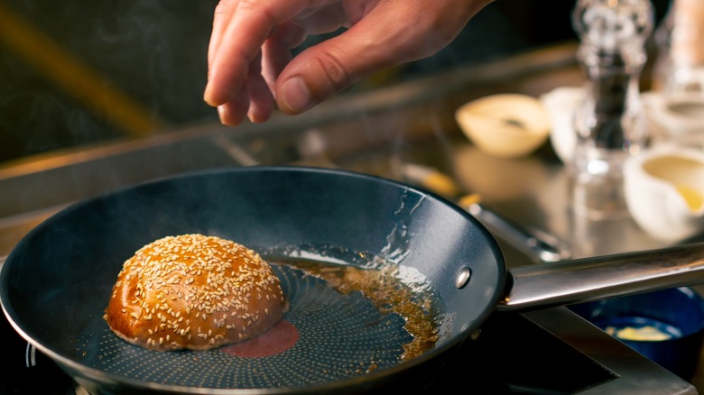 Person toasting a bun