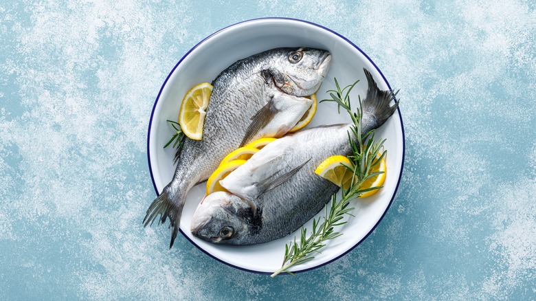 Two whole Dorado fish in a bowl