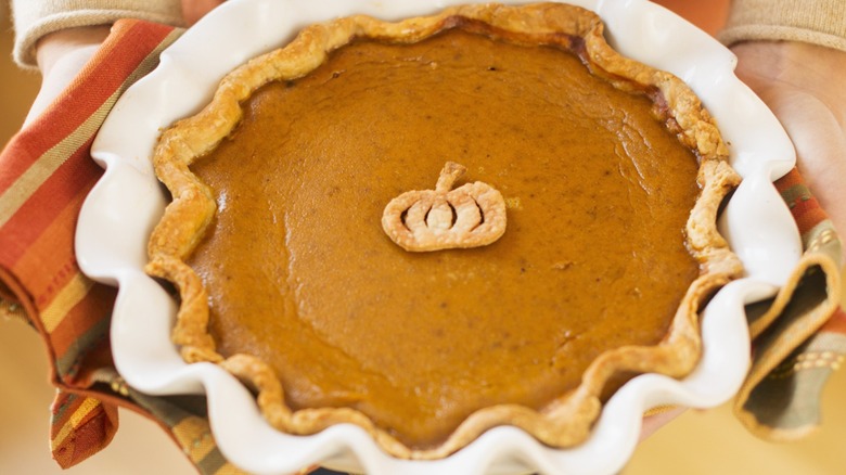 Fresh pumpkin pie with a mini pumpkin pie crust decoration