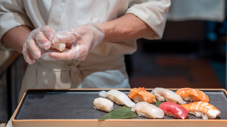 Sushi chef preparing nigiri sushi 