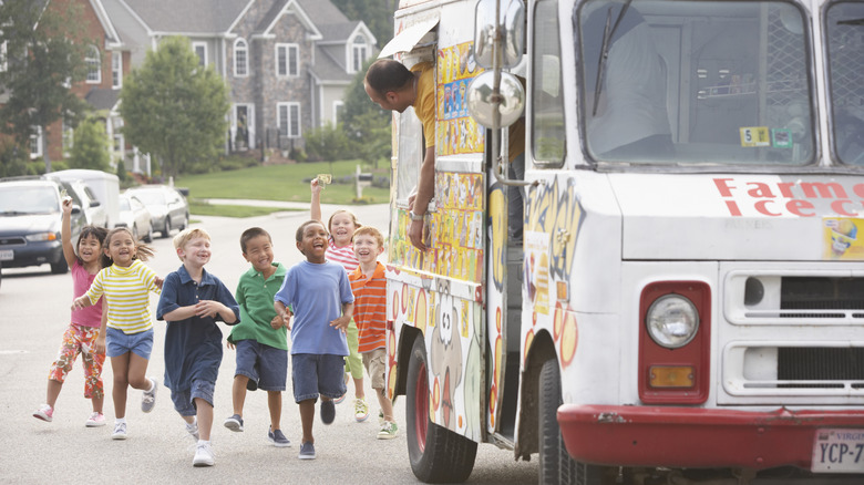 Children running towards an ice cream truck