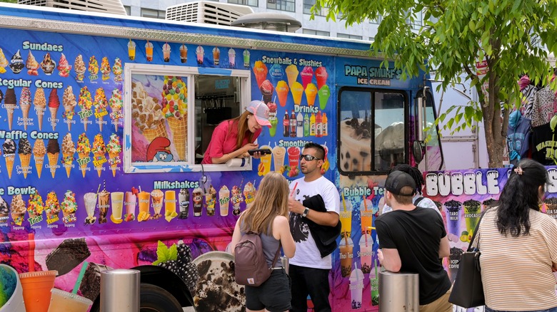 Ice cream truck and customers on street