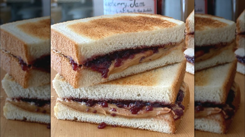 Peanut butter and jelly sandwich on toasted white bread.