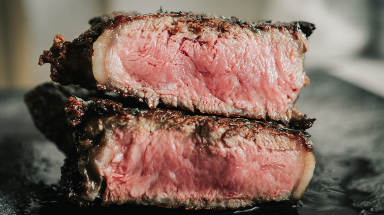 Pieces of New York Strip steak on top of one another