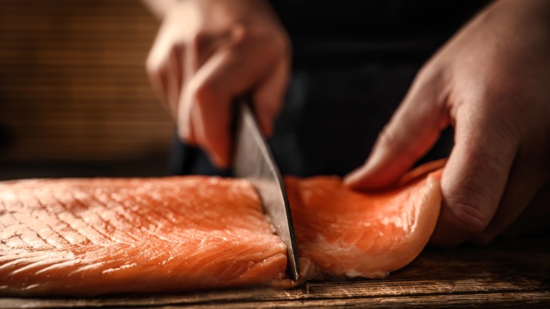 Person slicing salmon