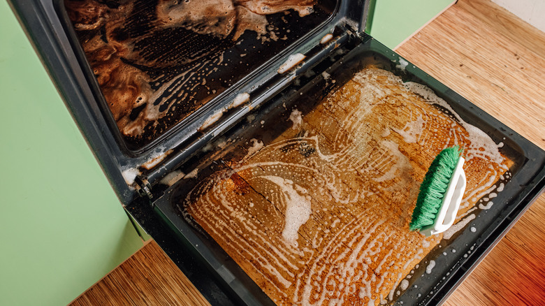 Soapy half-cleaned oven with grime