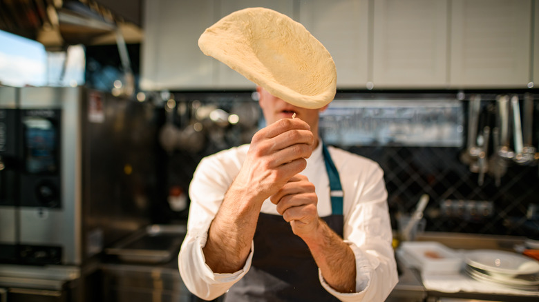 Chef tossing pizza dough
