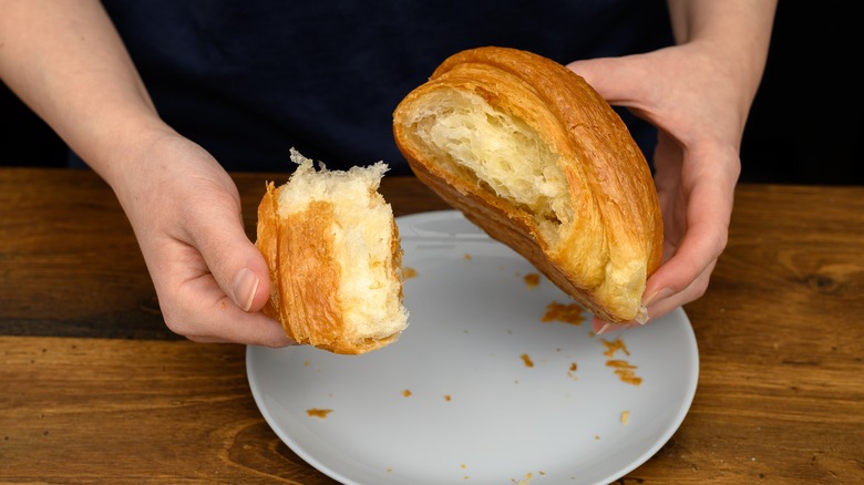 Tearing open a croissant