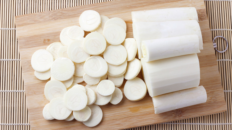 Sliced hearts of palm on wooden cutting board