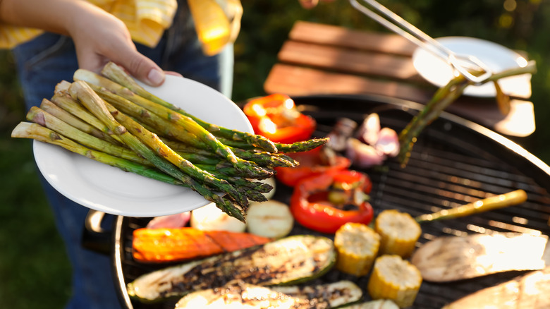 Person grilling vegetables