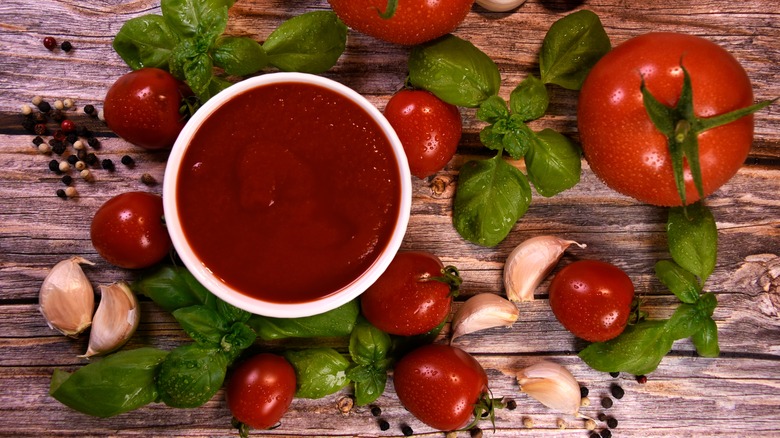 homemade ketchup surrounded by veggies