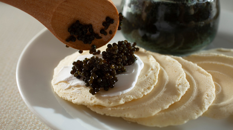 lumpfish caviar placed onto blini
