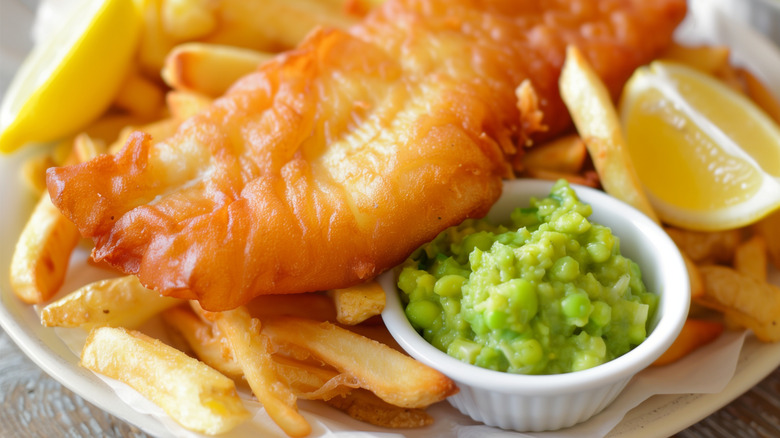 Fish and chips served with mushy peas and lemon