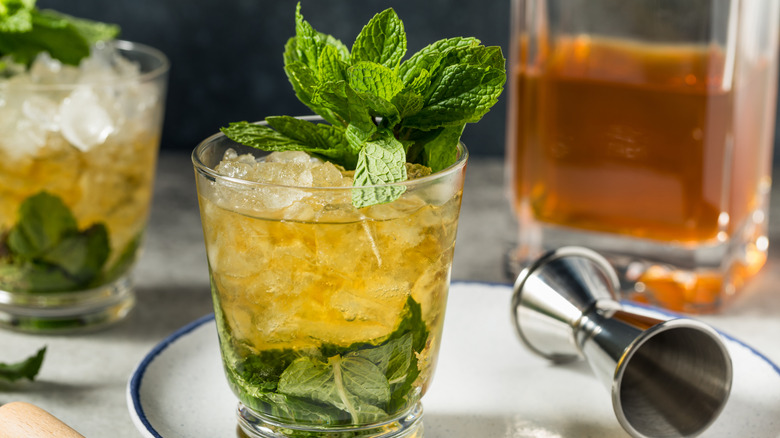 Mint Juleps in glasses topped with mint leaves