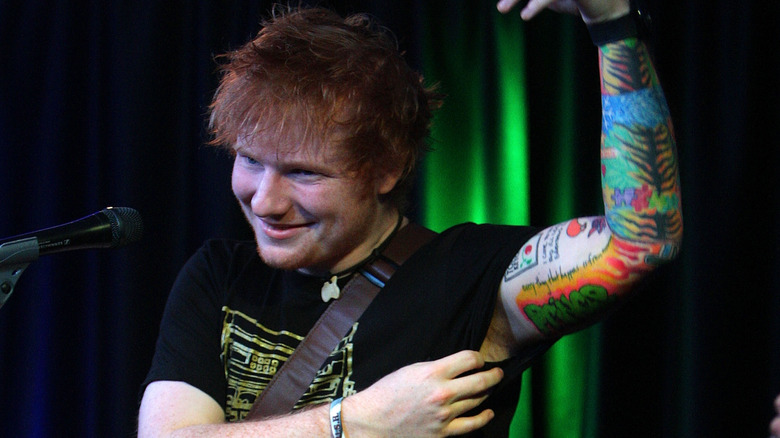 Ed Sheeran showing tattoo sleeve