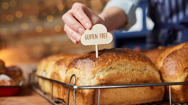 loaf of bread with a gluten free sign stuck in it