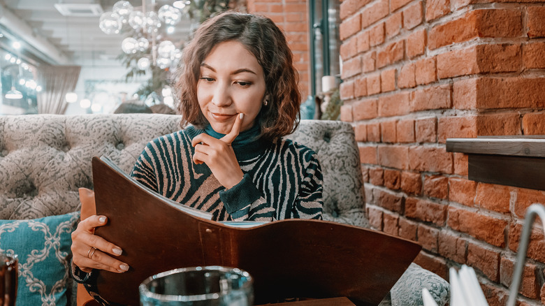 Woman reading a restaurant menu 