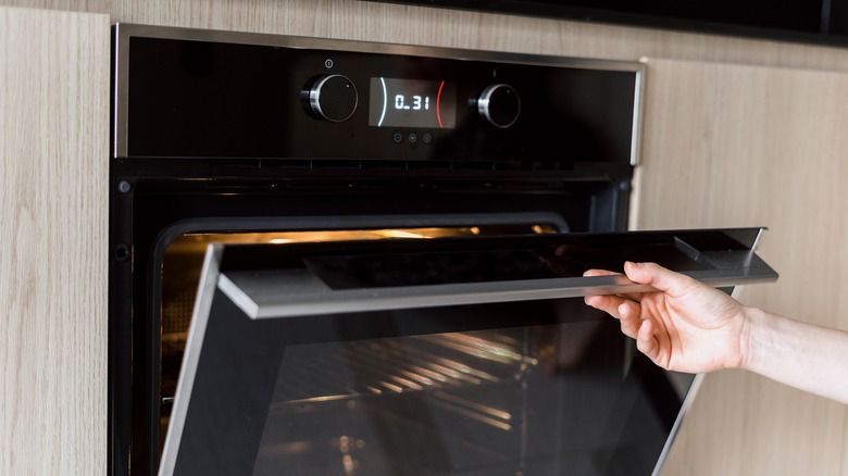 Person opening an oven