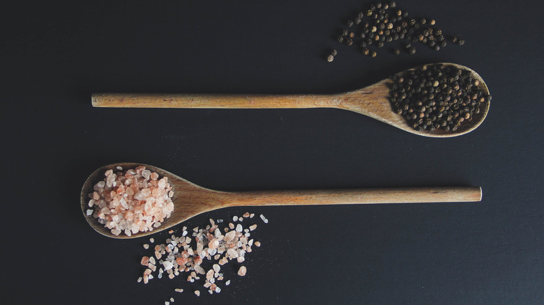 Salt and pepper in wooden spoons