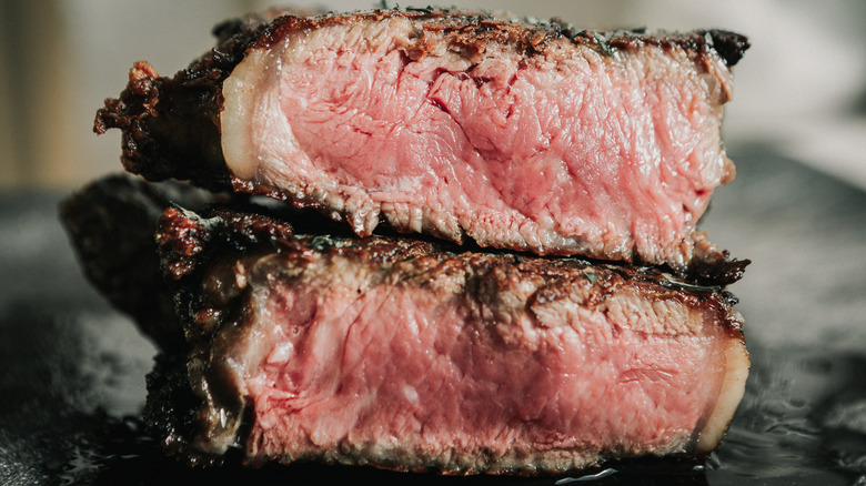 A stack of cut rare steaks