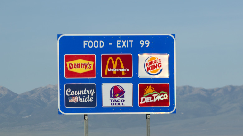 A highway exit sign with food options