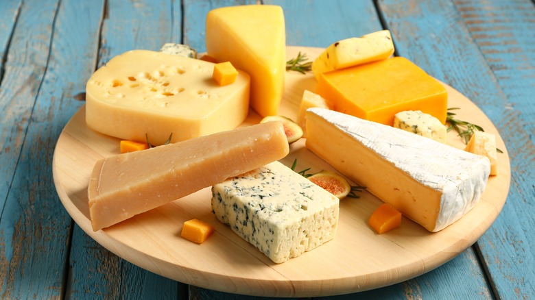 A cheeseboard with hard and soft cheese