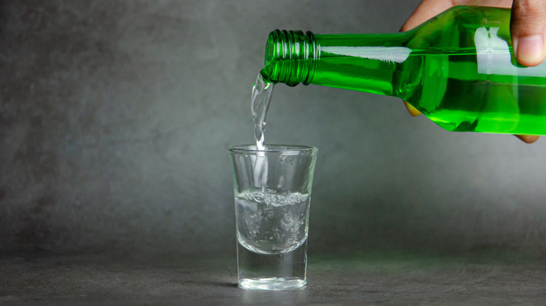 Soju being poured into shot glass