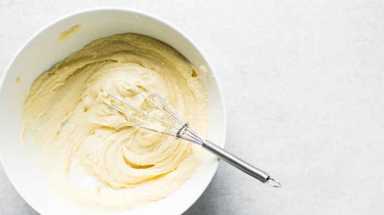 Whisk in bowl of butter and sugar being creamed